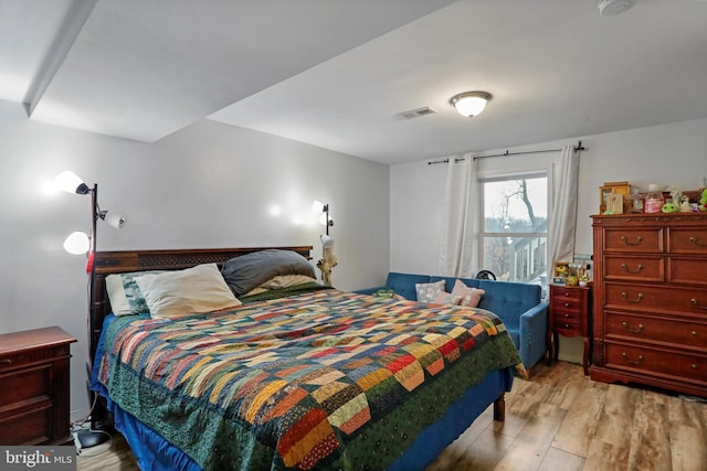 bedroom featuring light wood-type flooring and visible vents