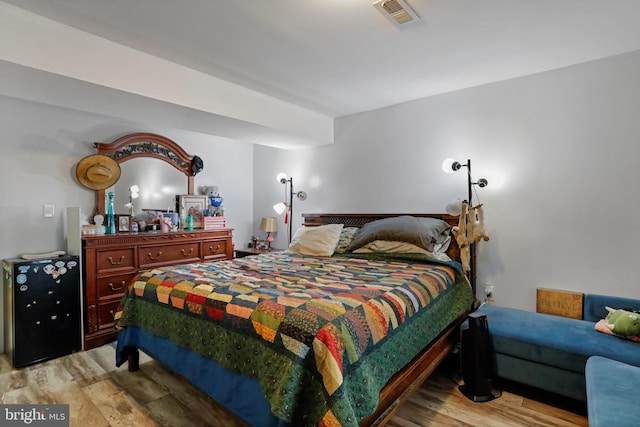 bedroom featuring visible vents and light wood-style flooring