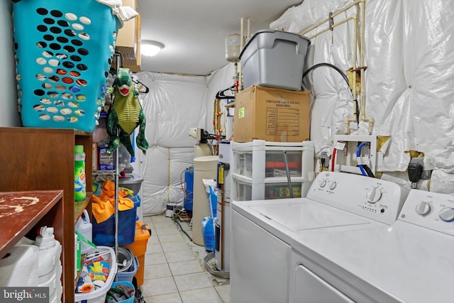 laundry area with washer and dryer and light tile patterned floors