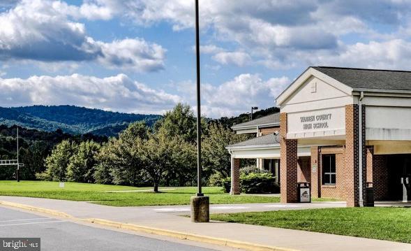 view of community with a lawn and a mountain view