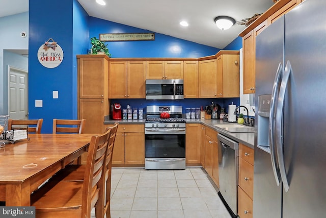 kitchen featuring light tile patterned floors, recessed lighting, stainless steel appliances, a sink, and vaulted ceiling