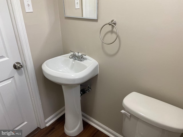 bathroom with wood-type flooring and toilet