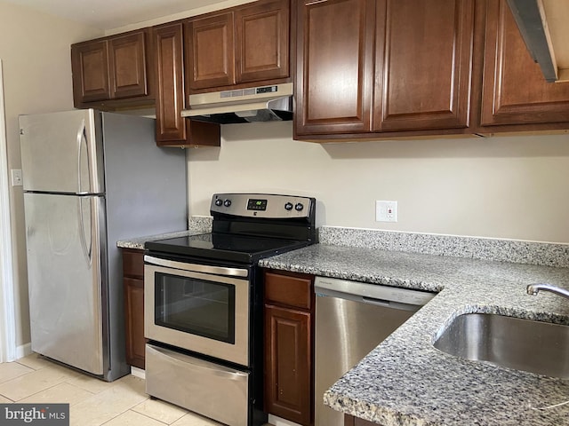 kitchen with light tile patterned flooring, appliances with stainless steel finishes, ventilation hood, and sink