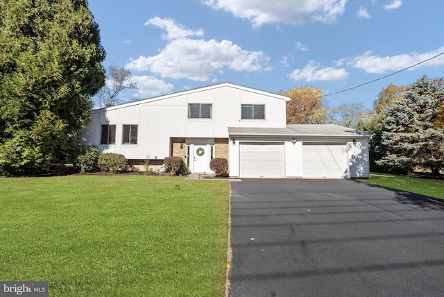 view of front of home featuring a garage and a front lawn