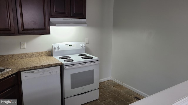 kitchen featuring dark brown cabinets and white appliances