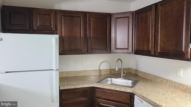 kitchen featuring sink and white appliances