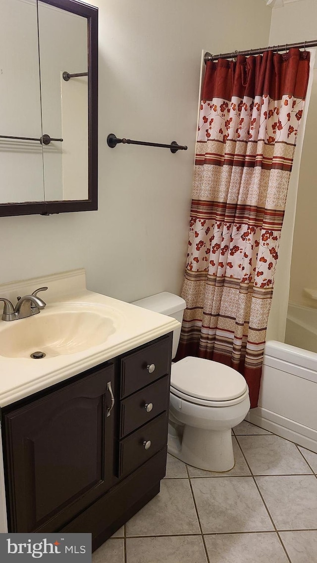 full bathroom with vanity, shower / bath combination with curtain, toilet, and tile patterned floors