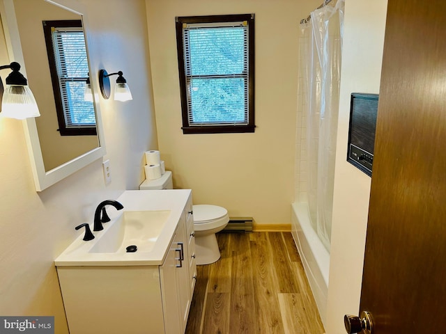 full bathroom with hardwood / wood-style flooring, vanity, a baseboard heating unit, toilet, and a healthy amount of sunlight