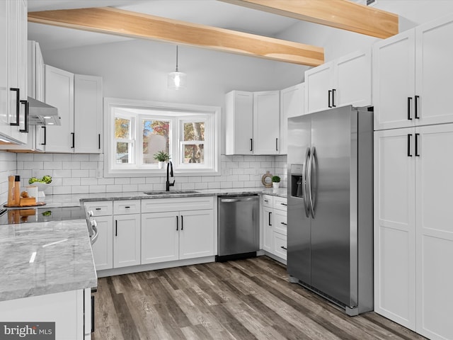 kitchen with white cabinets, stainless steel appliances, and wall chimney range hood