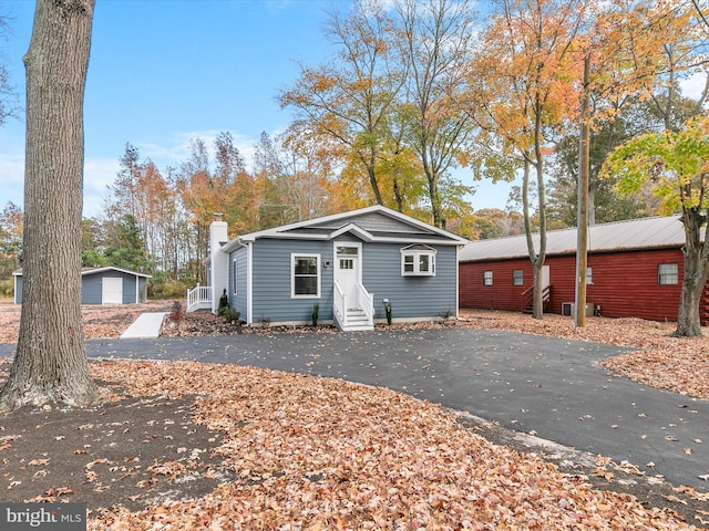 single story home with an outbuilding and a garage