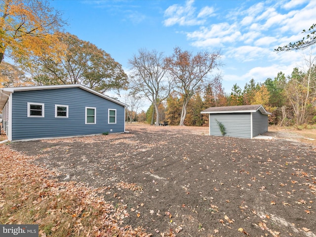 view of side of property featuring a storage unit