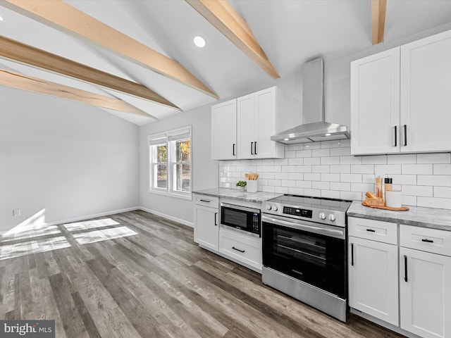 kitchen with white cabinets, appliances with stainless steel finishes, lofted ceiling with beams, and wall chimney exhaust hood