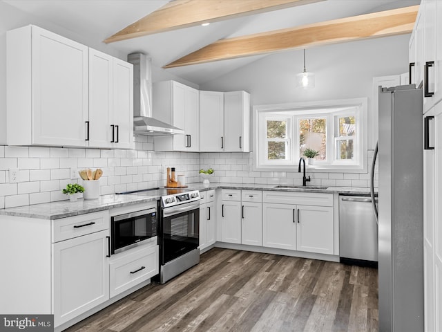 kitchen with white cabinets, vaulted ceiling with beams, wall chimney range hood, and stainless steel appliances