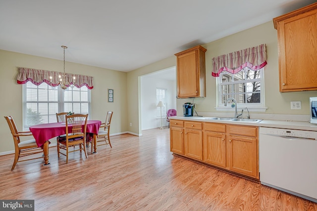 kitchen featuring light wood-type flooring, white appliances, a chandelier, and plenty of natural light