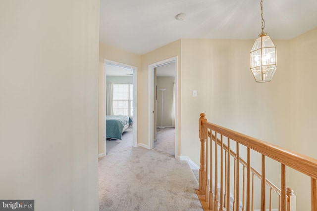 hall featuring light colored carpet