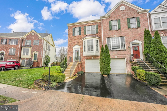 townhome / multi-family property with a garage and a front lawn