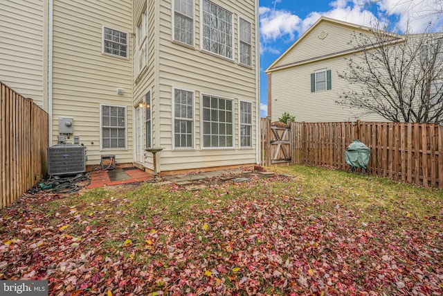 rear view of property with central AC unit