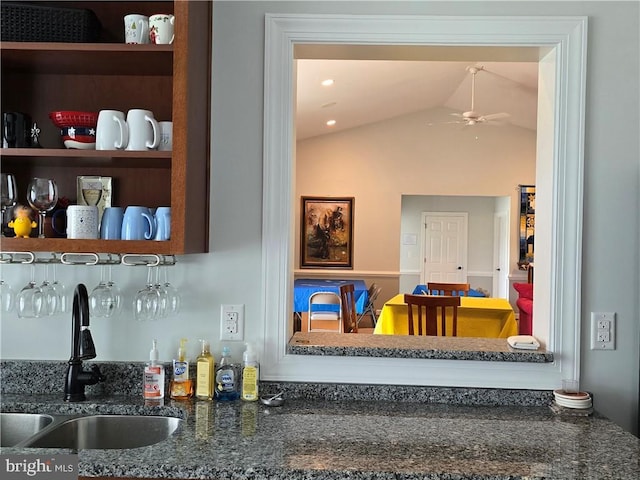 bar with ceiling fan, lofted ceiling, and sink