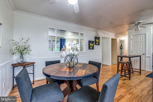 dining area featuring crown molding, ceiling fan, and light hardwood / wood-style floors