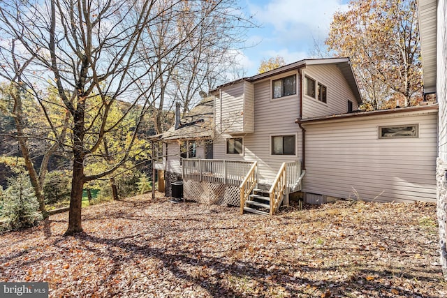 rear view of property with a wooden deck