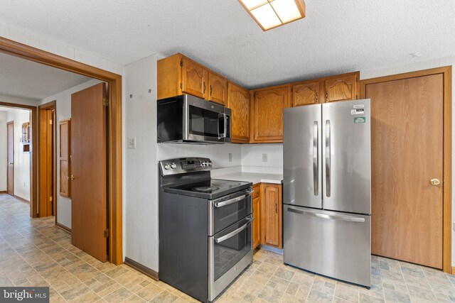 kitchen featuring a textured ceiling and appliances with stainless steel finishes