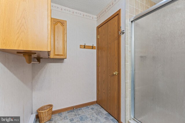 bathroom with a textured ceiling and walk in shower