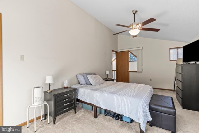 carpeted bedroom with vaulted ceiling and ceiling fan