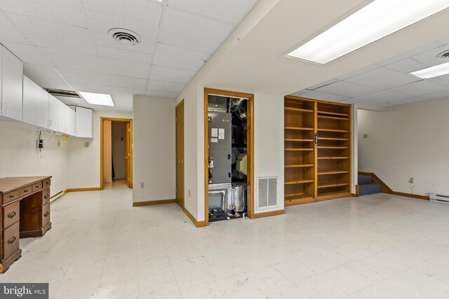 basement featuring a paneled ceiling