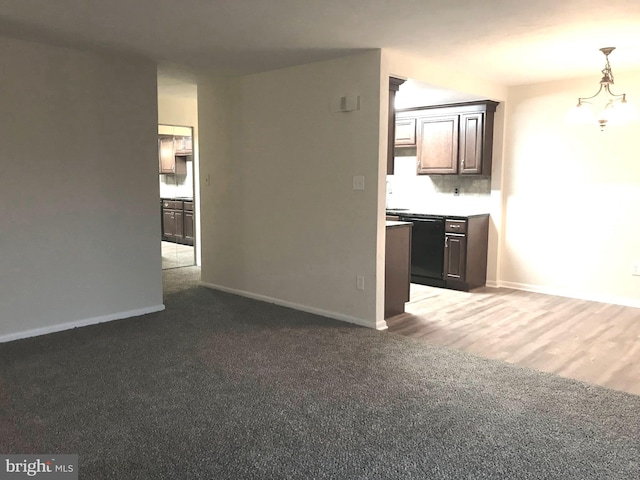 unfurnished living room featuring a notable chandelier and wood-type flooring