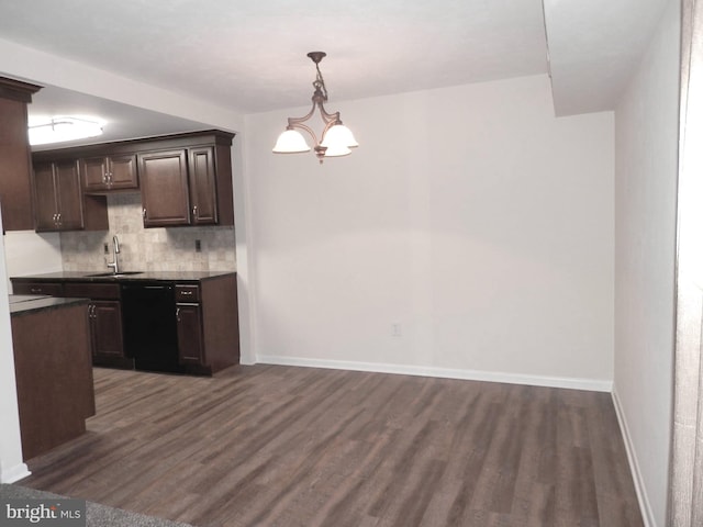 kitchen featuring black dishwasher, sink, backsplash, and dark hardwood / wood-style floors