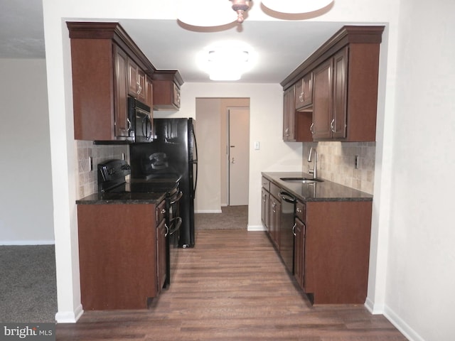 kitchen with sink, tasteful backsplash, dark hardwood / wood-style floors, and black appliances