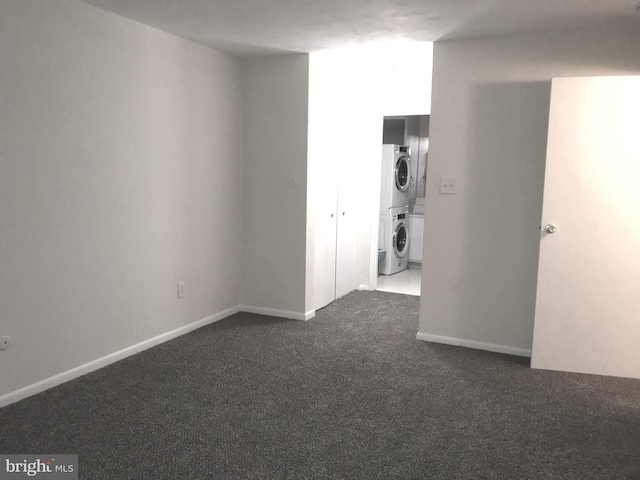 12 Dougherty Blvd Unit A5, Glen Mills, PA 19342 - empty room featuring stacked washer / drying machine, baseboards, and carpet flooring
