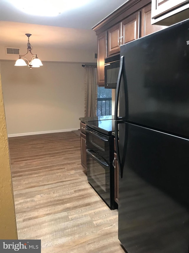 12 Dougherty Blvd Unit A5, Glen Mills, PA 19342 - kitchen with an inviting chandelier, light wood-type flooring, visible vents, baseboards, and black appliances