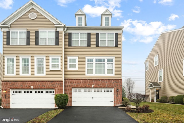 townhome / multi-family property featuring a garage