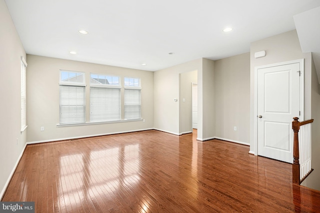 empty room with hardwood / wood-style flooring