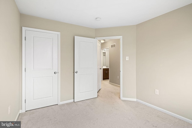 unfurnished bedroom featuring light carpet