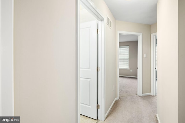 hallway with light carpet