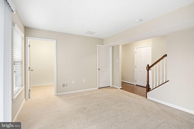 spare room featuring light colored carpet