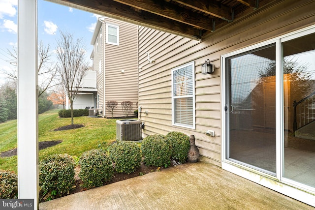 exterior space featuring a lawn and central AC unit