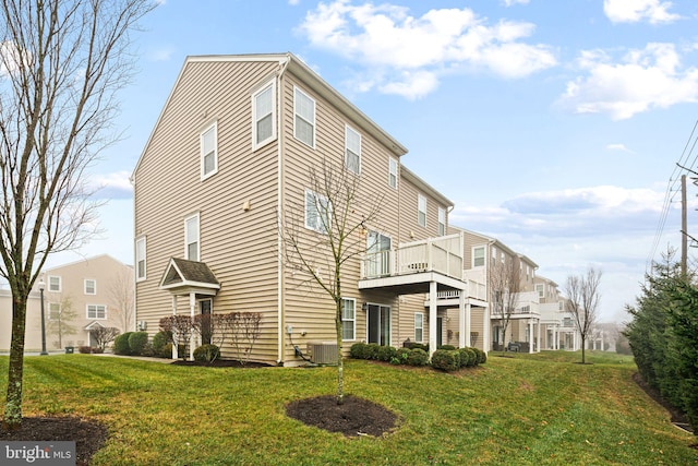 view of property exterior with a lawn, central AC, and a balcony