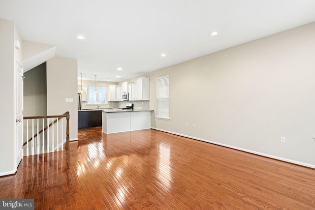 unfurnished living room featuring hardwood / wood-style floors