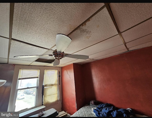 room details featuring a paneled ceiling and ceiling fan