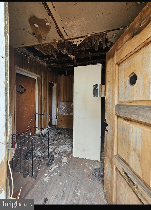 miscellaneous room featuring wood walls