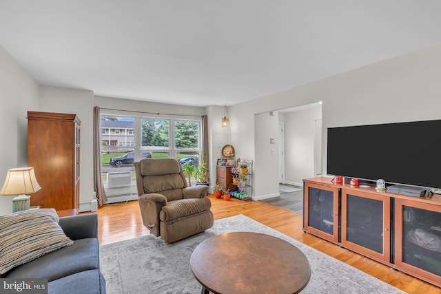 living room featuring light hardwood / wood-style flooring and a baseboard heating unit