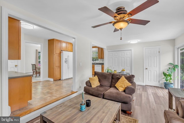 living room featuring light hardwood / wood-style flooring and ceiling fan