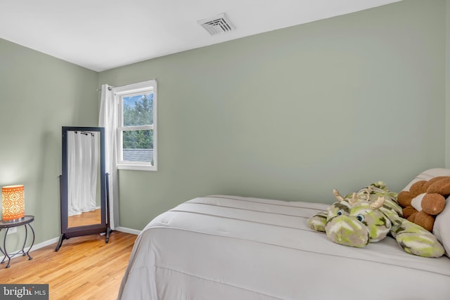 bedroom with wood-type flooring