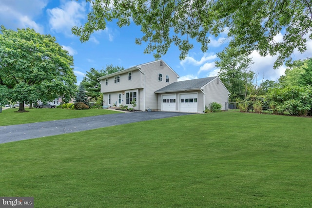 view of front of home with a front lawn and a garage