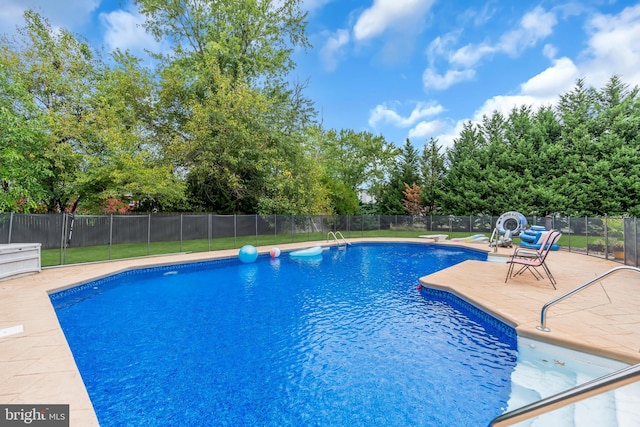 view of swimming pool with a patio