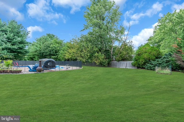 view of yard featuring a patio area and a fenced in pool