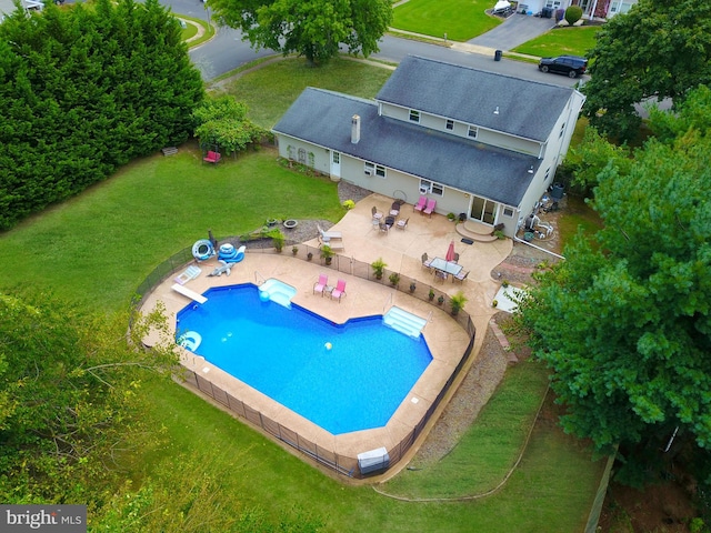 view of swimming pool featuring a patio area and a lawn